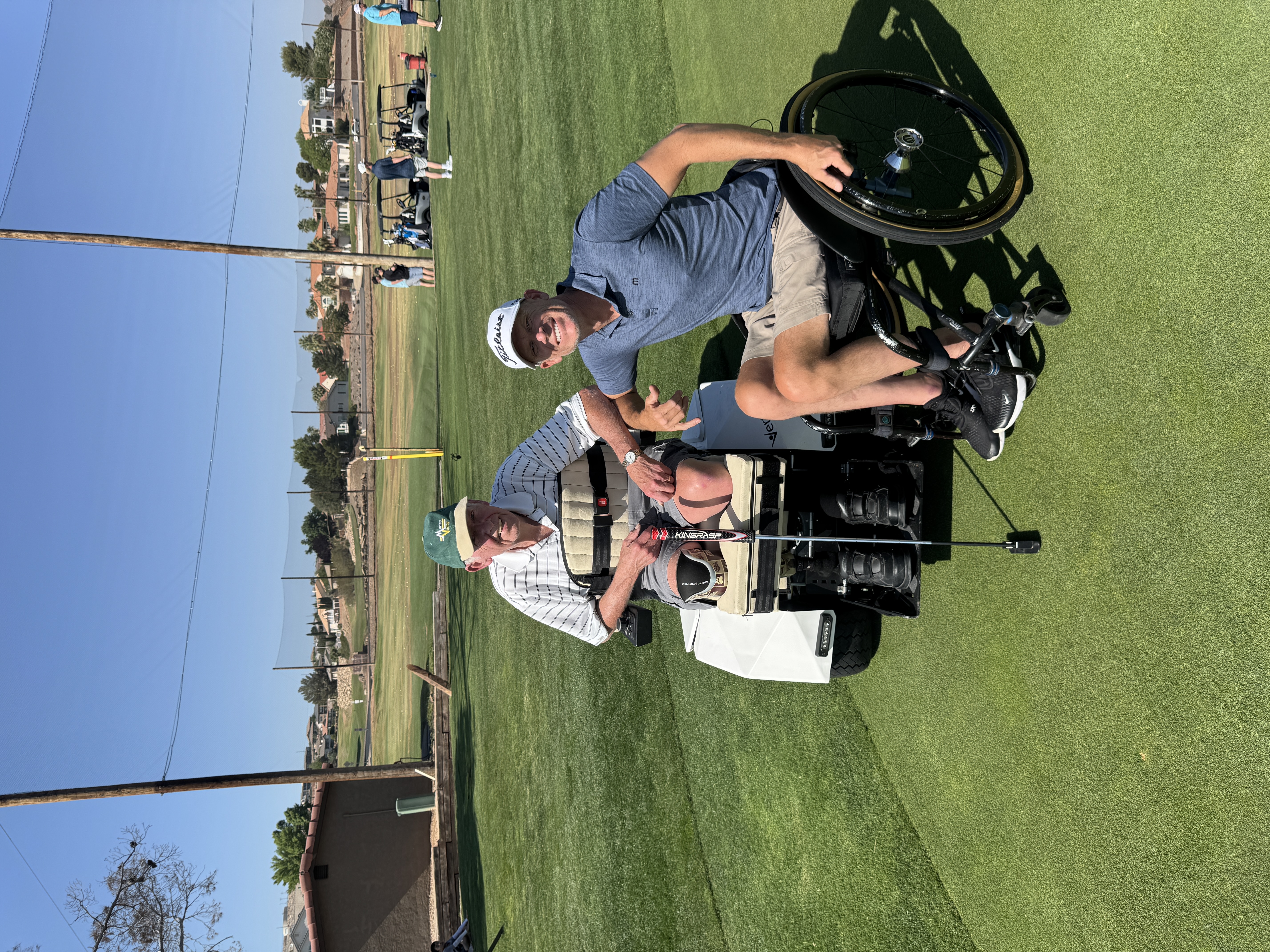 Two golfers on the fairway, red rocks