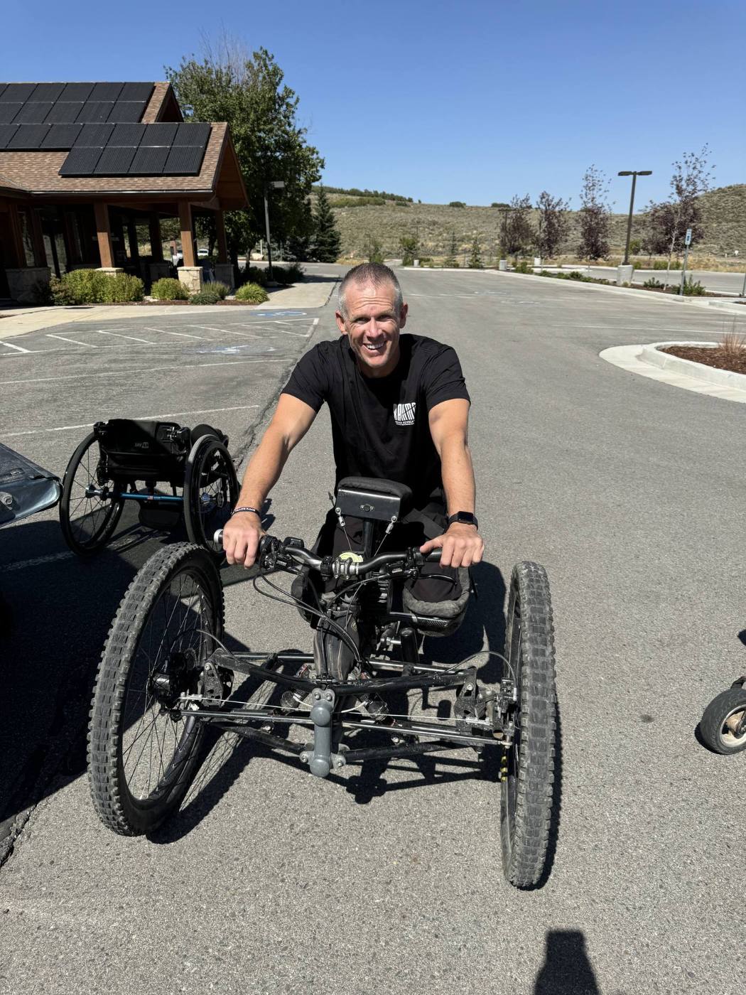 Matt on adaptive hand cycle smiling